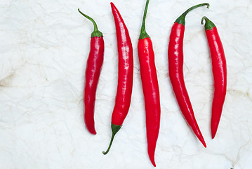 Image showing five red hot chili peppers