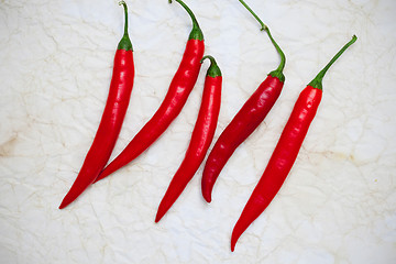 Image showing red hot chili pepper on a old paper surface