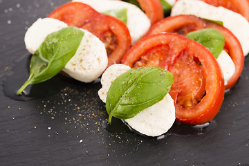 Image showing Caprese salad with mozzarella, tomato, basil and balsamic vinega