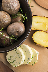 Image showing  baked potatoes with herbs butter