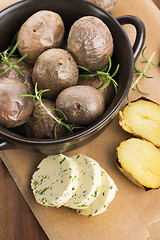Image showing  baked potatoes with herbs butter