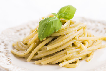 Image showing Italian pasta spaghetti with pesto sauce and basil leaf