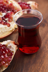 Image showing Ripe pomegranates with juice on table