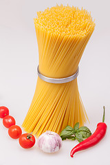 Image showing Spaghetti standing with fresh spices and vegetables, raw