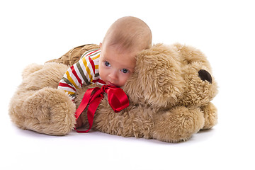 Image showing baby boy over plush dog on white background