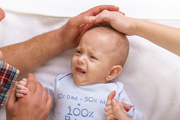 Image showing parents calm a crying baby