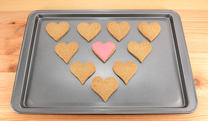 Image showing Heart-shaped biscuits on a cookie sheet