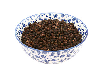 Image showing Black peppercorns in a blue and white china bowl