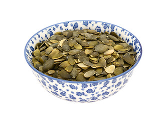 Image showing Pumpkin seeds in a blue and white china bowl