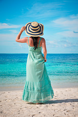 Image showing Girl walking along a tropical beach in the Maldives.