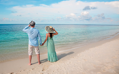 Image showing Vacation Couple walking on tropical beach Maldives.