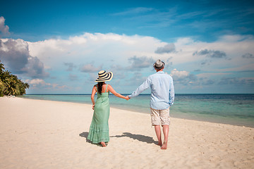 Image showing Vacation Couple walking on tropical beach Maldives.