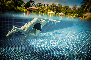 Image showing Couple floating in the pool on holiday