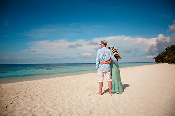 Image showing Vacation Couple walking on tropical beach Maldives.