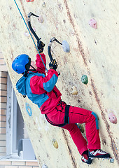 Image showing Man climbs upward on ice climbing competition