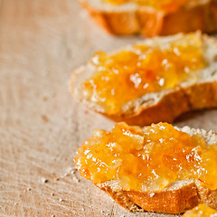 Image showing pieces of baguette with orange marmalade