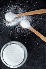 Image showing sugar in wooden spoons and glass jar 