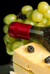 Image showing Grape wine with cheese on black