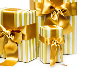 Image showing Gold gift boxes isolated on white background