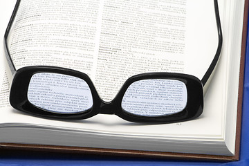 Image showing Glasses on a book