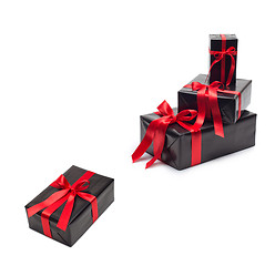 Image showing Black gift box with red satin ribbon and bow