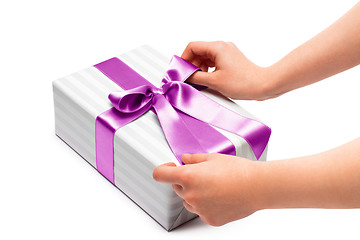 Image showing hand holding ribbon and open gift box