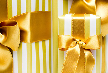 Image showing Gold gift boxes  background