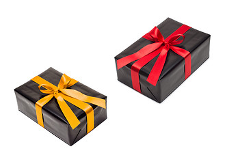 Image showing two gift boxes with yellow and red satin ribbon