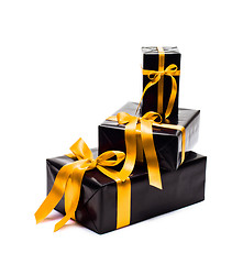 Image showing Black gift box with yellow satin ribbon and bow