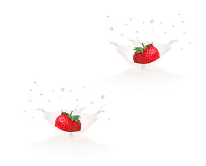 Image showing Strawberry falling into milk