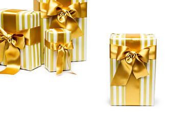 Image showing Gold gift boxes isolated on white