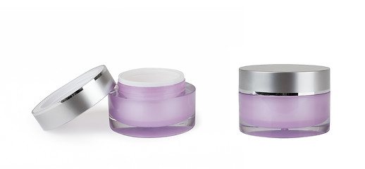 Image showing two purple containers of cream on white background