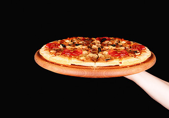 Image showing Tasty pizza in wooden plate