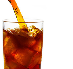 Image showing Cola is pouring into glass on white background
