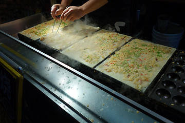 Image showing Takoyaki chefs prepare takoyaki 