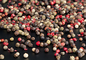 Image showing Red, black, green and white peppercorns