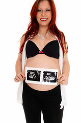 Image showing Happy girl with ultrasound picture.