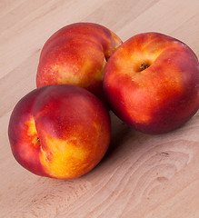 Image showing Three tasty fresh ripe juicy nectarines