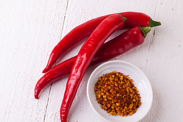 Image showing Fresh red and yellow chili peppers with spice