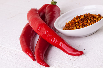 Image showing Fresh red and yellow chili peppers with spice