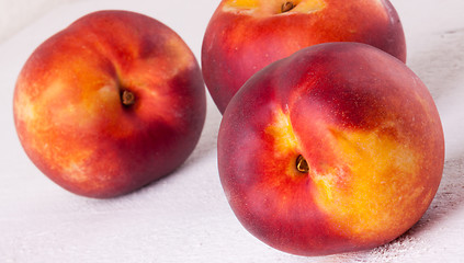 Image showing Three tasty fresh ripe juicy nectarines