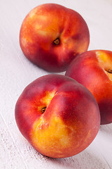 Image showing Three tasty fresh ripe juicy nectarines