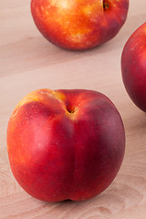 Image showing Three tasty fresh ripe juicy nectarines