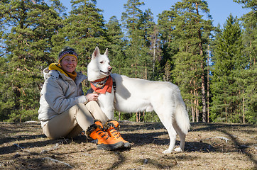 Image showing The woman with a white dog in a wood