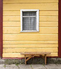 Image showing bench near the wooden wall with window