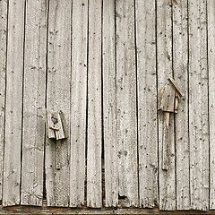 Image showing two old broken homemade birdhouses