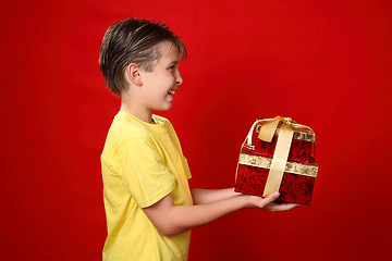 Image showing Smiling boy giving Christmas presents