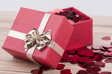 Image showing Red hearts confetti in box