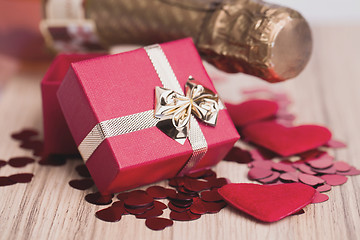 Image showing bottle of vine, red hearts and small present