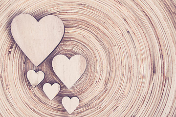 Image showing valentine's wooden hearts on a wooden background in retro color